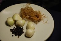 Ingredients for Thai Chicken Soup: Coriander Root, Black Peppercorns, and Garlic